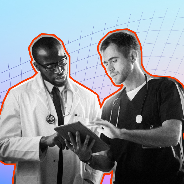 Two healthcare professionals on a tablet device