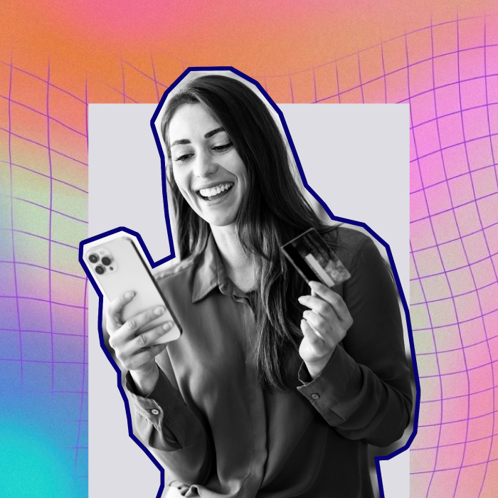 Woman shopping on a mobile device with credit card in hand on a gradient background