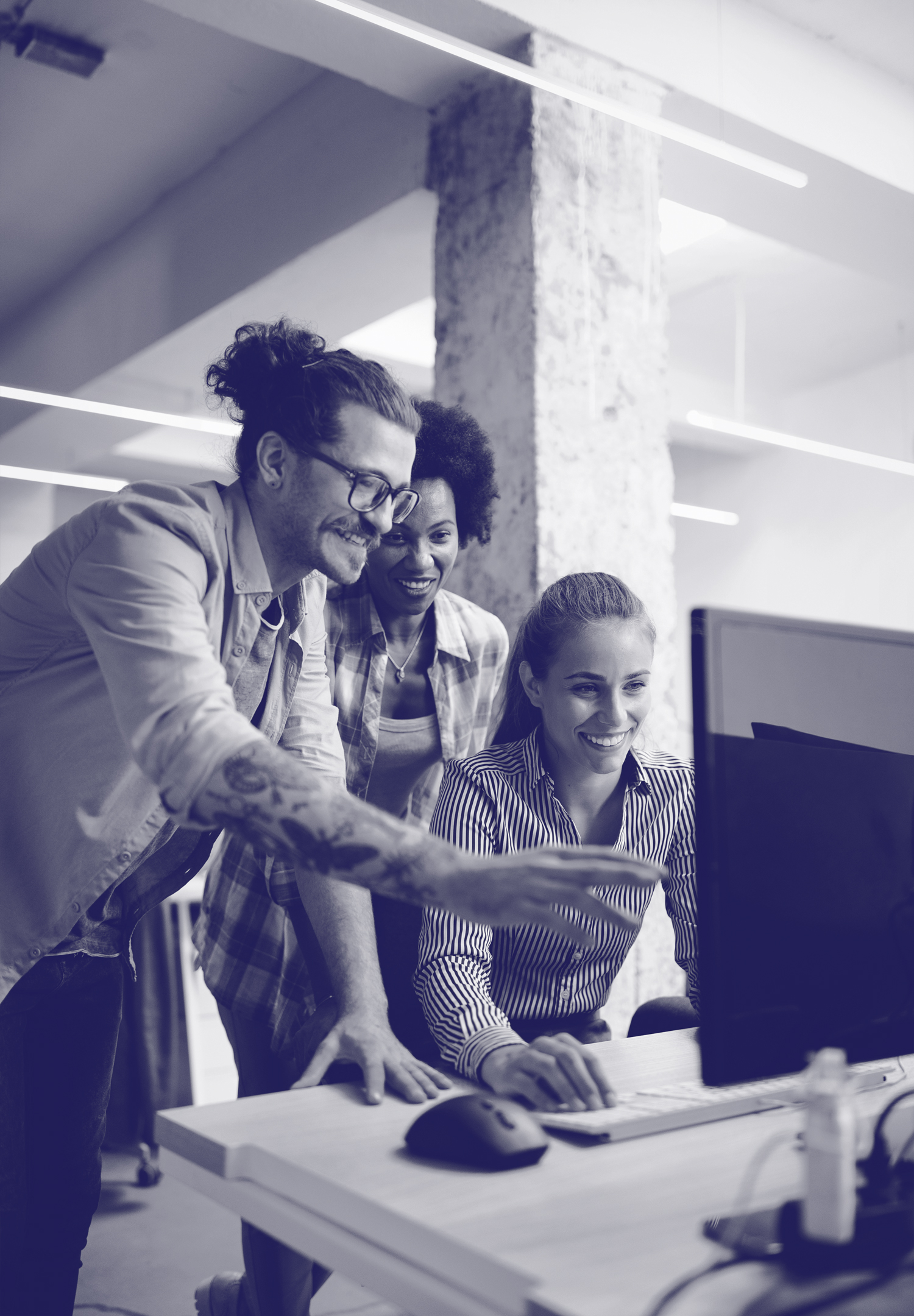3 young marketing team members working together in Optimizely on a computer