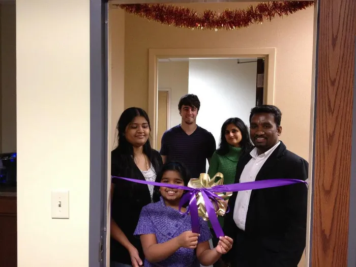 Suresh Devanan and his family cutting the ribbon on the first Nishtech office, 2012.